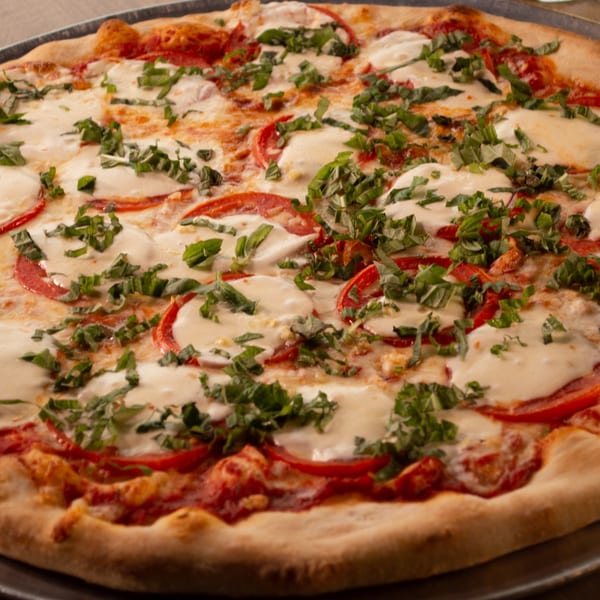 Mike's Pizza and Pub's Margherita pizza with fresh mozzarella, sliced tomatoes, and basil.